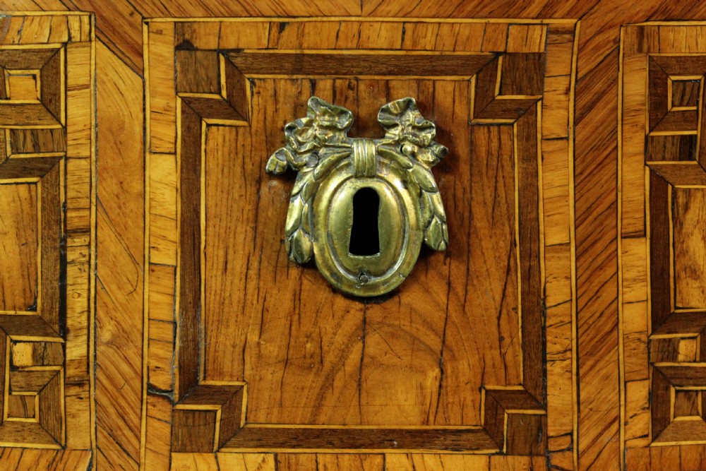 A Louis XV style kingwood commode featuring three drawers with geometric parquetry inlay, gilt bronze mounts, and a shaped grey marble top. View V