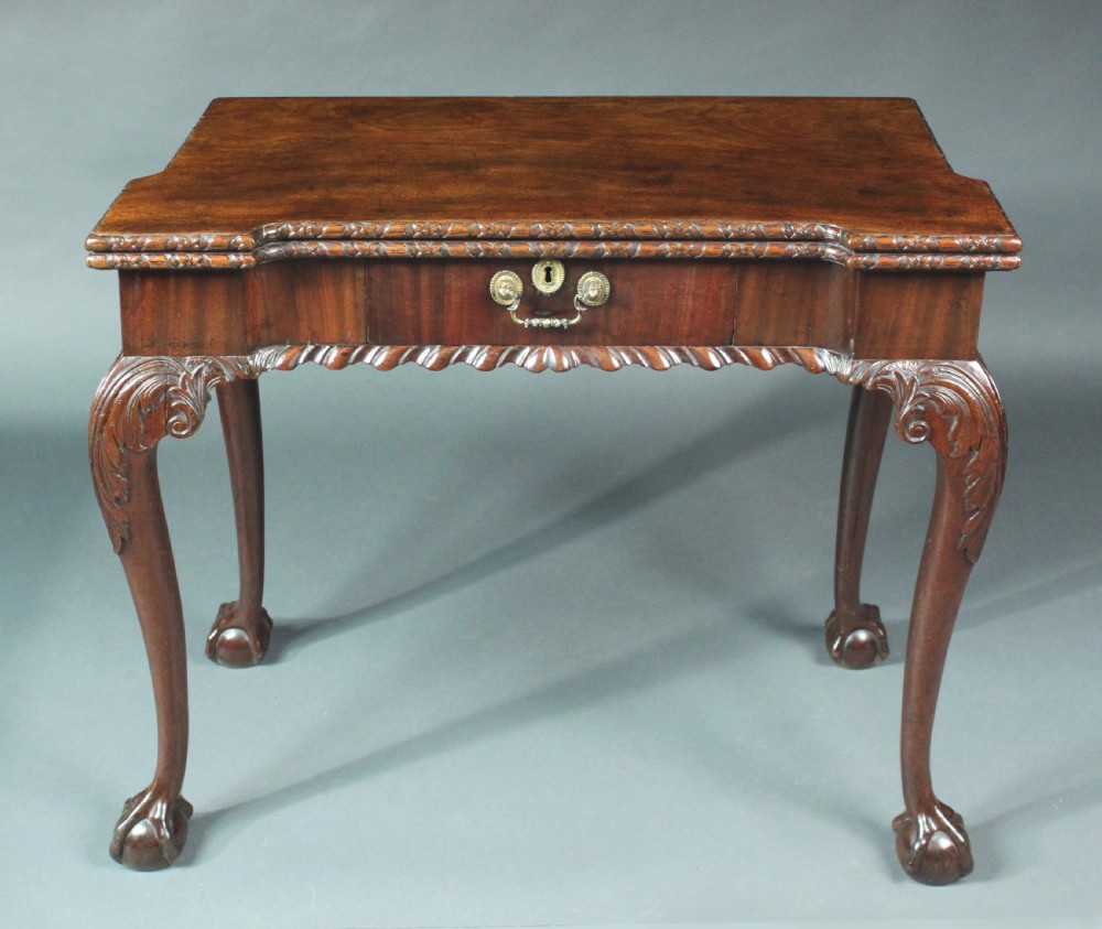 An antique Chippendale mahogany fold-over card table with cabriole legs, carved ball and claw feet, and a single drawer with brass hardware. View III