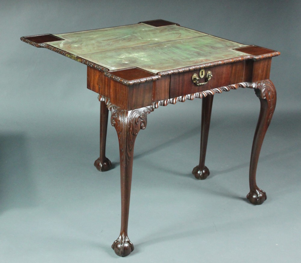 An antique Chippendale mahogany fold-over card table with cabriole legs, carved ball and claw feet, and a single drawer with brass hardware. View VI