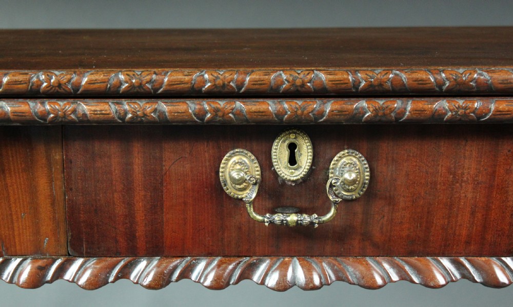 An antique Chippendale mahogany fold-over card table with cabriole legs, carved ball and claw feet, and a single drawer with brass hardware. View IX