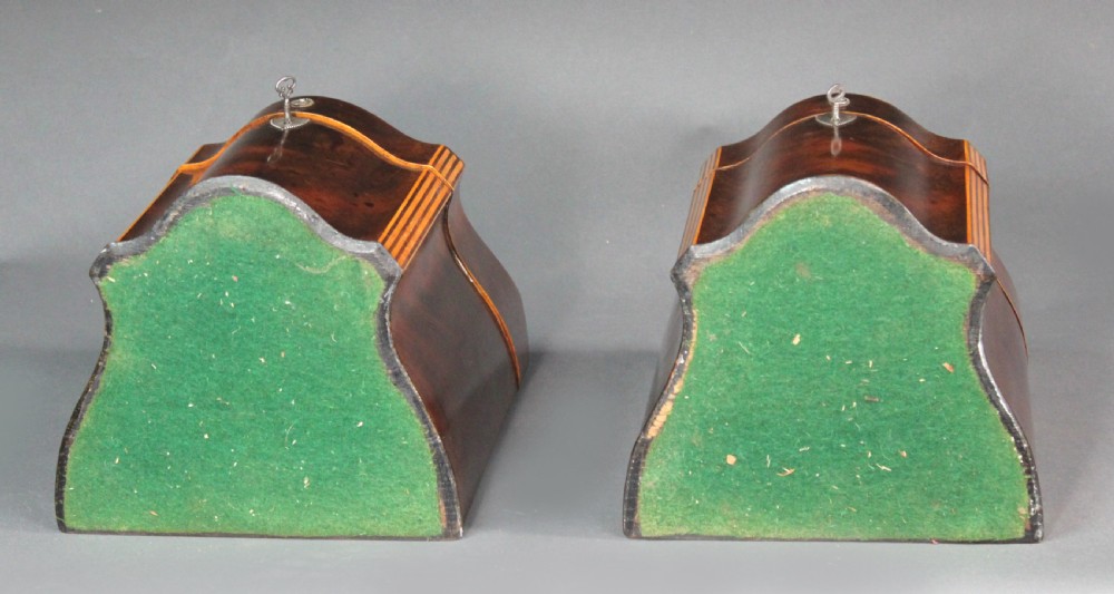 A pair of open Georgian mahogany knife boxes featuring slanted tops, star inlay on the inner lids, and slotted interior cutlery compartments. View III