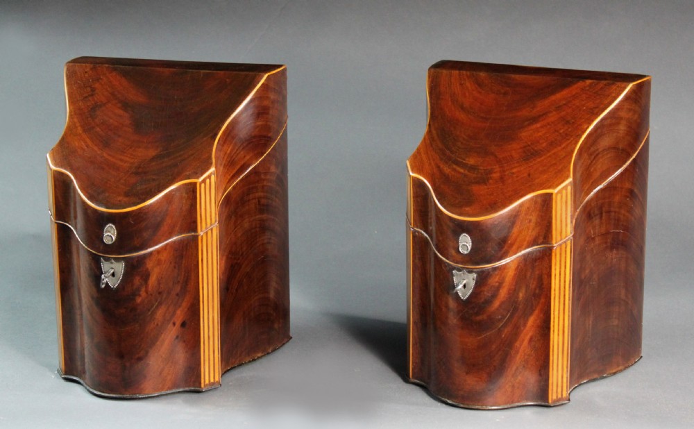 A pair of open Georgian mahogany knife boxes featuring slanted tops, star inlay on the inner lids, and slotted interior cutlery compartments. View IV