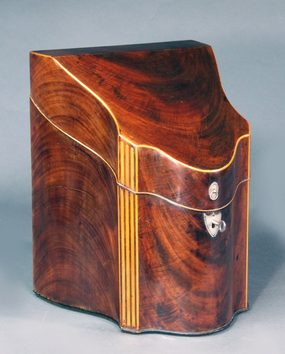 A pair of open Georgian mahogany knife boxes featuring slanted tops, star inlay on the inner lids, and slotted interior cutlery compartments. View VI