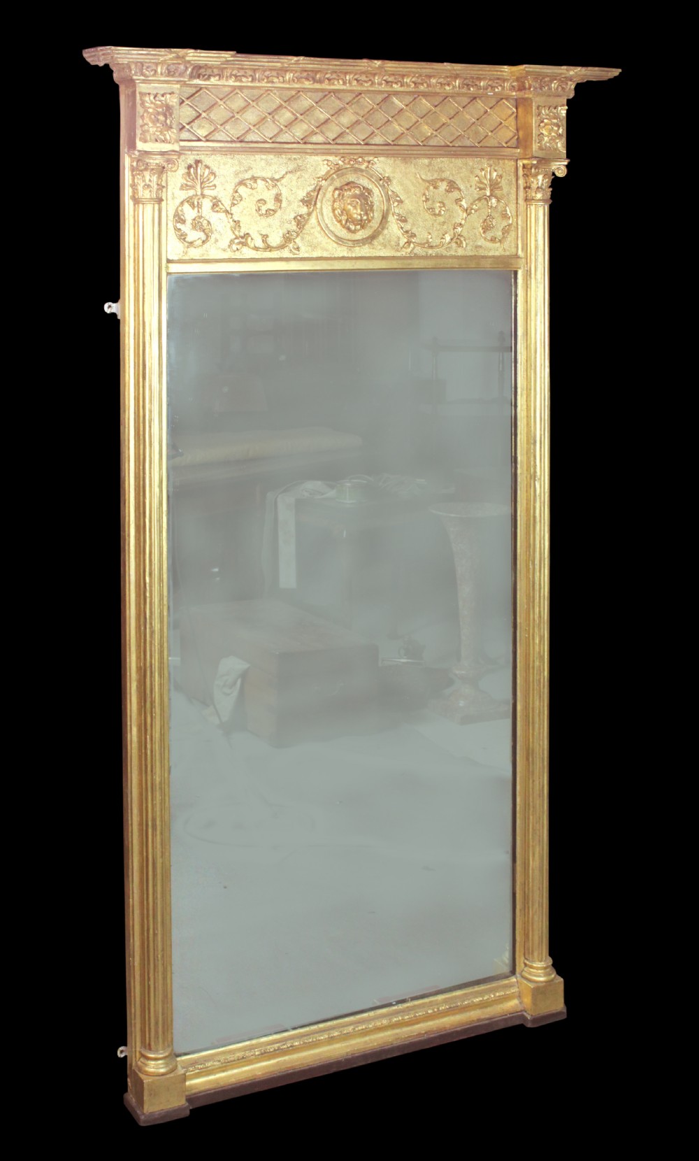 A tall Regency giltwood pier glass featuring fluted pilasters, a decorative lattice frieze, and a central lion mask motif. View II