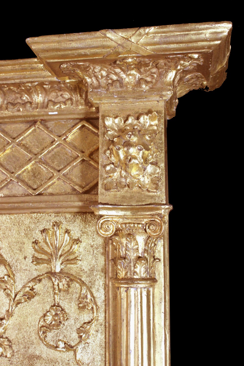 A tall Regency giltwood pier glass featuring fluted pilasters, a decorative lattice frieze, and a central lion mask motif. View IV