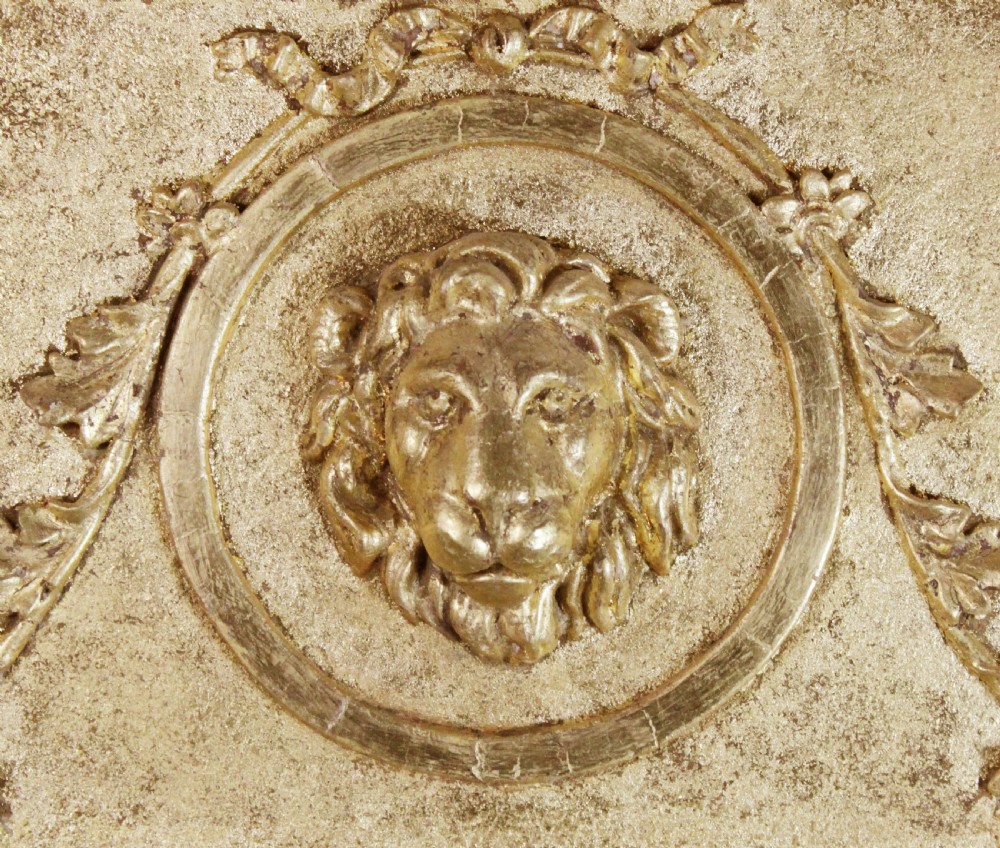 A tall Regency giltwood pier glass featuring fluted pilasters, a decorative lattice frieze, and a central lion mask motif. View V