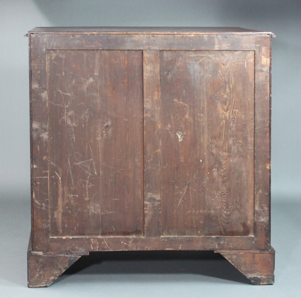 An 18th-century George III flame mahogany cupboard with two panelled doors, brass escutcheon, and a shaped bracket foot base. View V