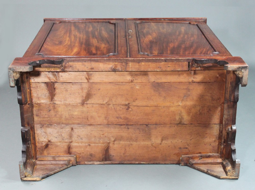 An 18th-century George III flame mahogany cupboard with two panelled doors, brass escutcheon, and a shaped bracket foot base. View VI