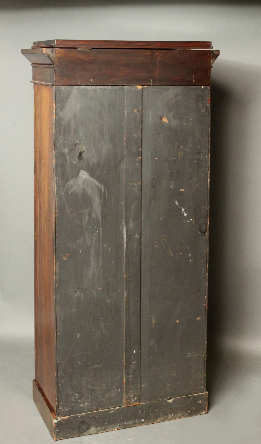 A tall, narrow Victorian rosewood Wellington chest featuring seven stacked drawers with wooden knob handles and a hinged side locking bar. View XI