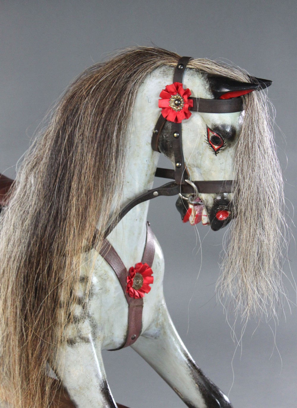 A 19th-century carved wooden dapple grey rocking horse mounted on a stained timber safety glider stand with leather tack and a natural horsehair mane. View IV