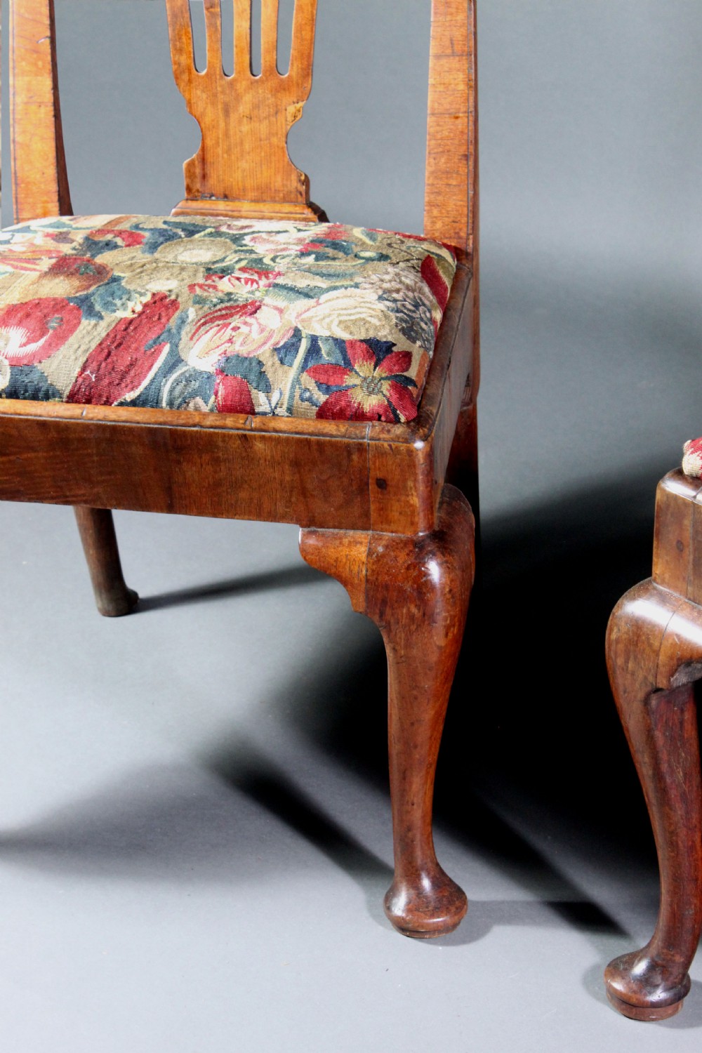 A pair of 18th-century George II walnut side chairs featuring pierced vase-shaped splats, floral upholstered drop-in seats, and front cabriole legs. View IV