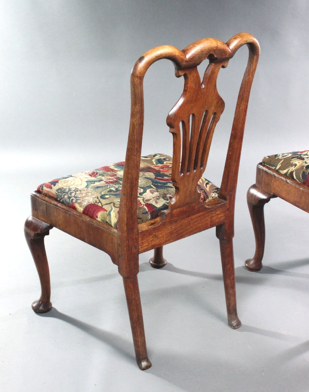 A pair of 18th-century George II walnut side chairs featuring pierced vase-shaped splats, floral upholstered drop-in seats, and front cabriole legs. View VII