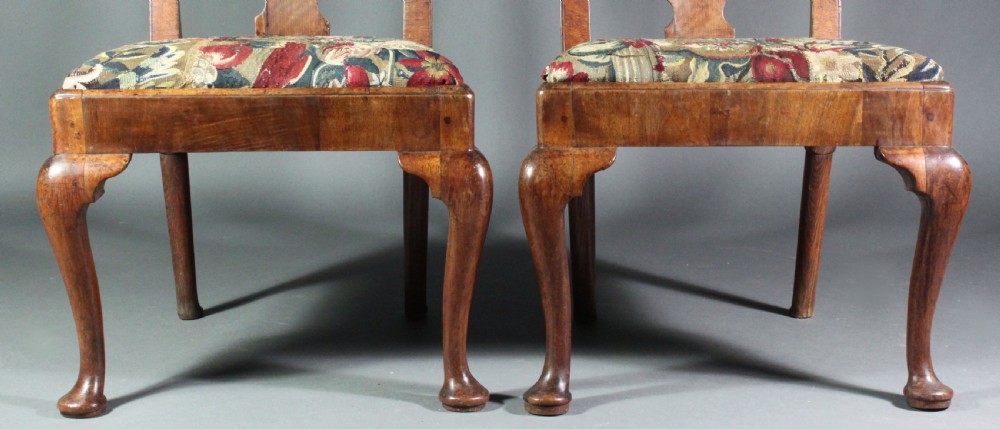 A pair of 18th-century George II walnut side chairs featuring pierced vase-shaped splats, floral upholstered drop-in seats, and front cabriole legs. View IX