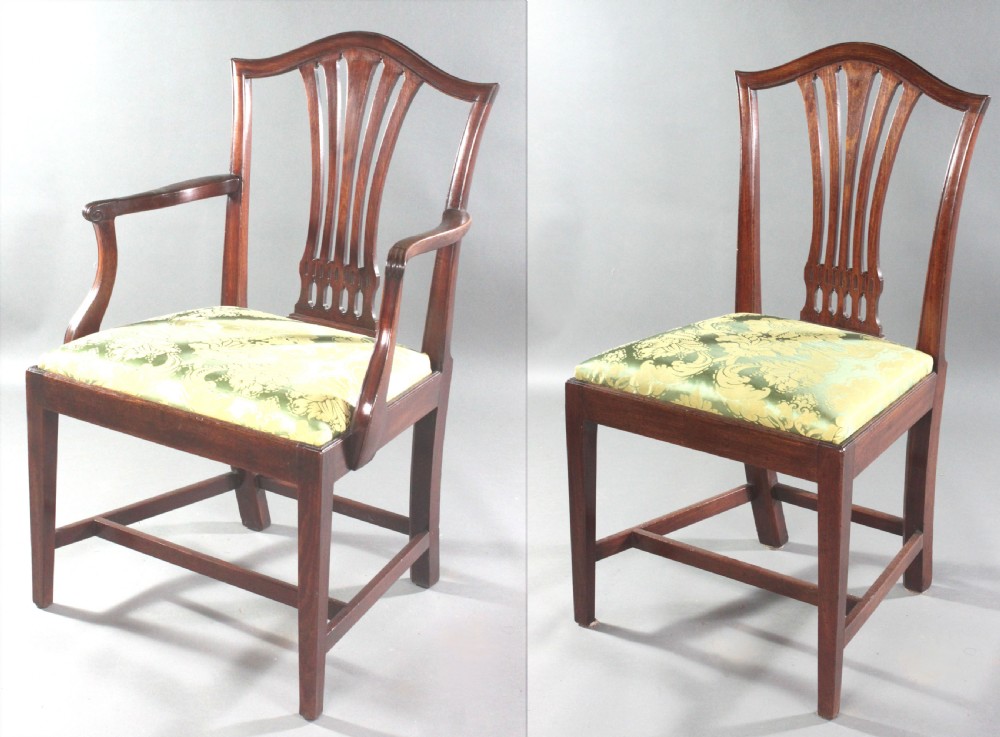 A set of eight Georgian mahogany dining chairs featuring carved pierced back splats and green damask upholstered seats, including six side chairs and two armchairs. View III