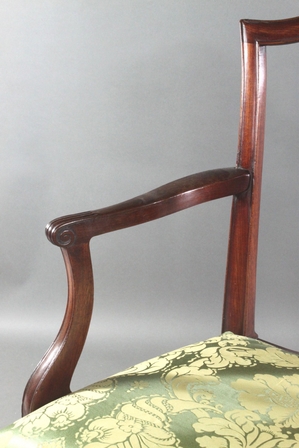 A set of eight Georgian mahogany dining chairs featuring carved pierced back splats and green damask upholstered seats, including six side chairs and two armchairs. View VII