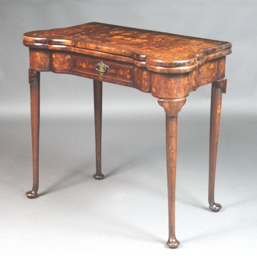 An antique Dutch walnut card table featuring detailed floral marquetry inlay, a serpentine frieze with a single drawer, and slender legs. View II