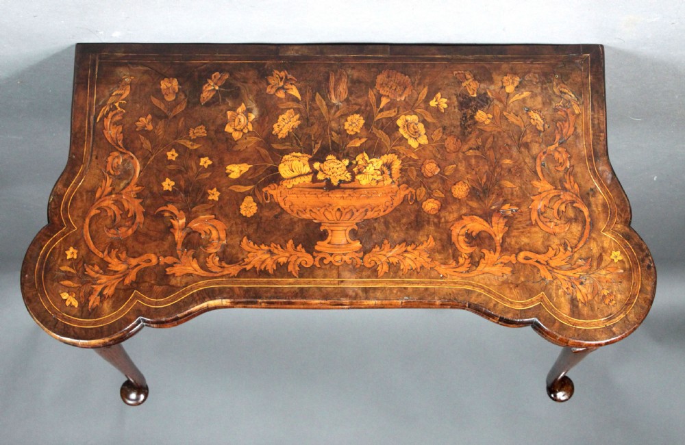 An antique Dutch walnut card table featuring detailed floral marquetry inlay, a serpentine frieze with a single drawer, and slender legs. View III