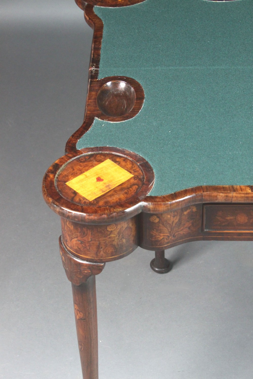 An antique Dutch walnut card table featuring detailed floral marquetry inlay, a serpentine frieze with a single drawer, and slender legs. View VII