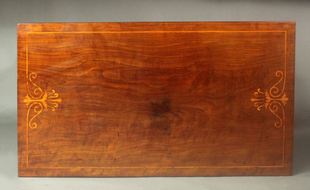 A rectangular Regency mahogany centre table featuring corner inlay, carved scroll supports, a lower stretcher shelf, and carved lion paw feet. View IV