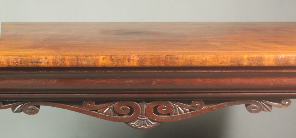 A rectangular Regency mahogany centre table featuring corner inlay, carved scroll supports, a lower stretcher shelf, and carved lion paw feet. View VII