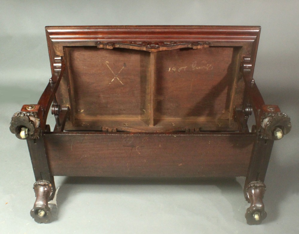 A rectangular Regency mahogany centre table featuring corner inlay, carved scroll supports, a lower stretcher shelf, and carved lion paw feet. View IX