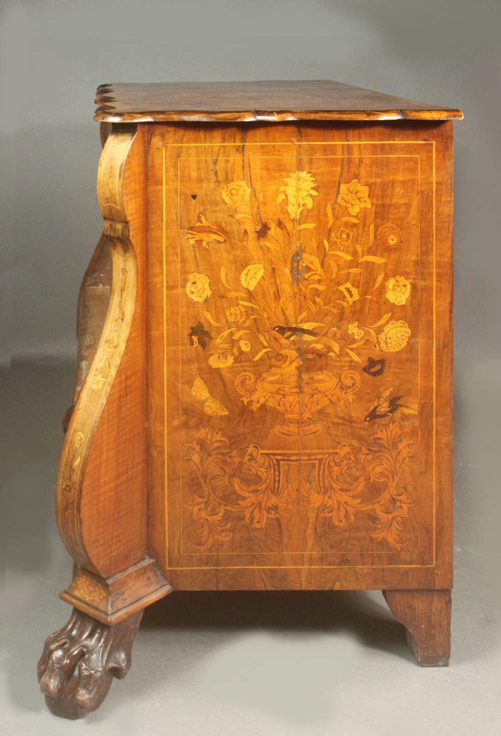 An antique Dutch walnut bombe chest featuring detailed floral marquetry inlays, four drawers, cast brass handles, and carved claw and ball feet. View VIII