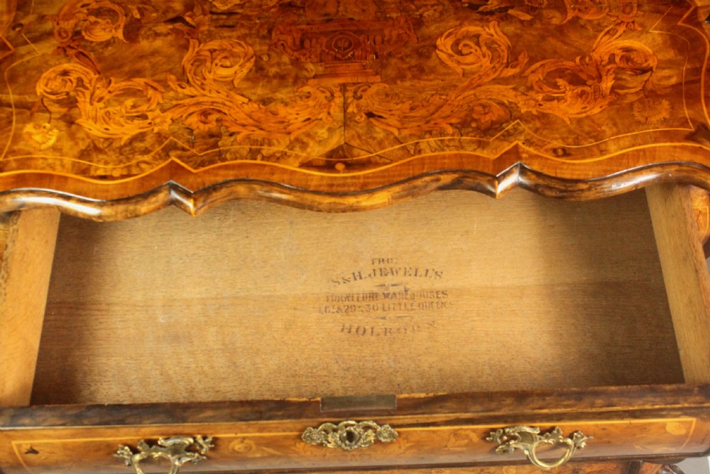 An antique Dutch walnut bombe chest featuring detailed floral marquetry inlays, four drawers, cast brass handles, and carved claw and ball feet. View XI