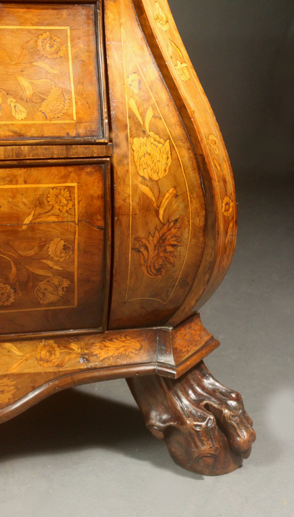 An antique Dutch walnut bombe chest featuring detailed floral marquetry inlays, four drawers, cast brass handles, and carved claw and ball feet. View XIII