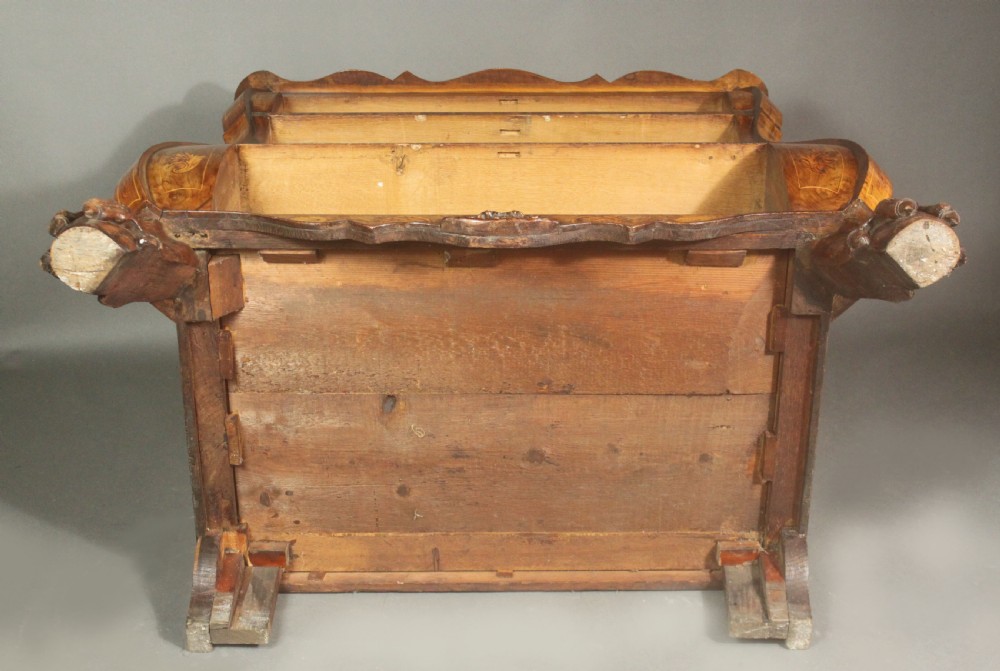 An antique Dutch walnut bombe chest featuring detailed floral marquetry inlays, four drawers, cast brass handles, and carved claw and ball feet. View XV