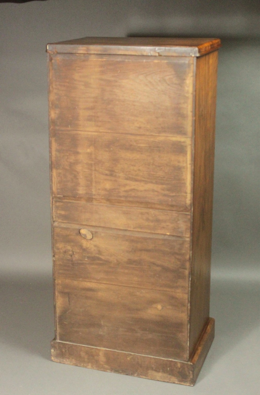 A tall Victorian walnut Wellington chest featuring seven graduated drawers with turned wooden knobs, carved upper corbels, and a right-hand hinged locking flap. View XIII