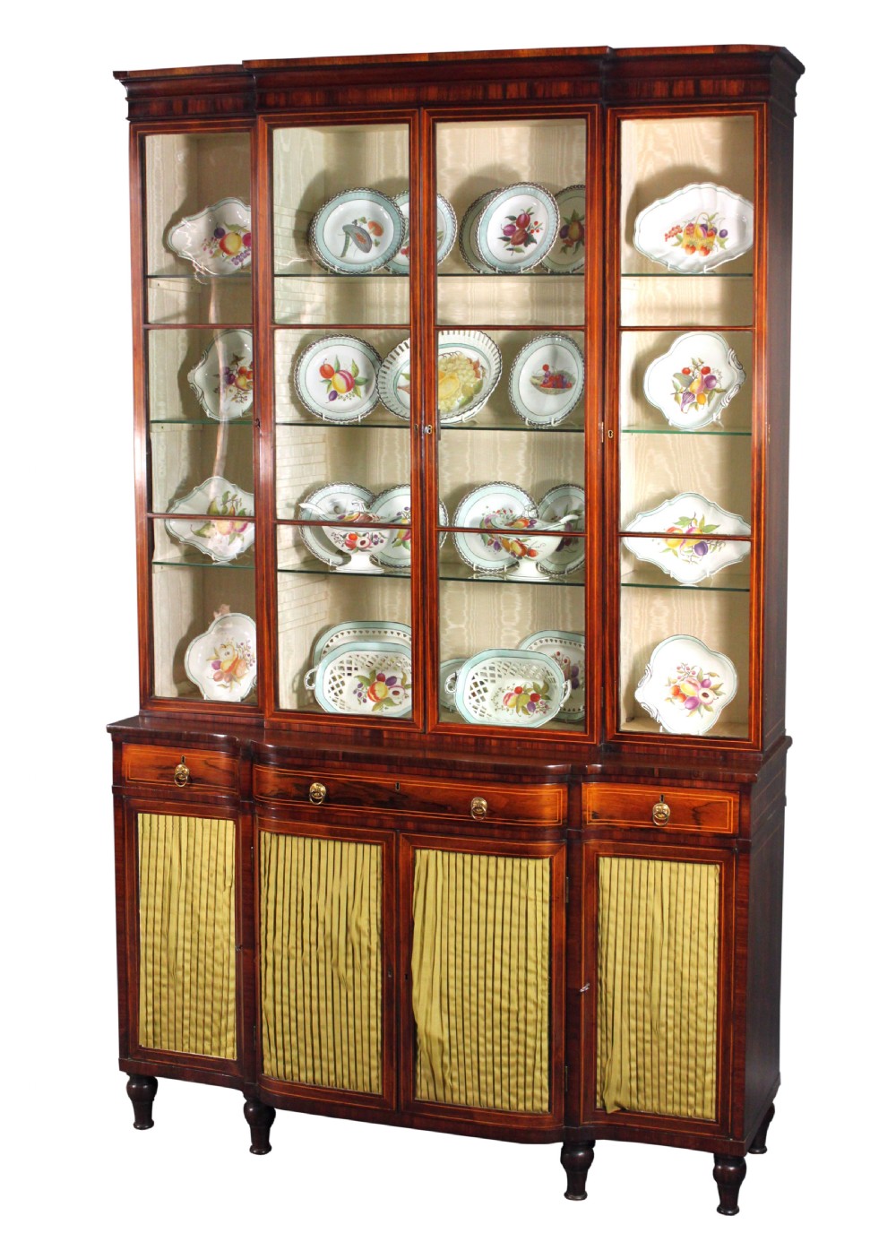 A Regency rosewood breakfront bookcase featuring four glazed upper doors and four lower doors lined with pleated fabric. View III