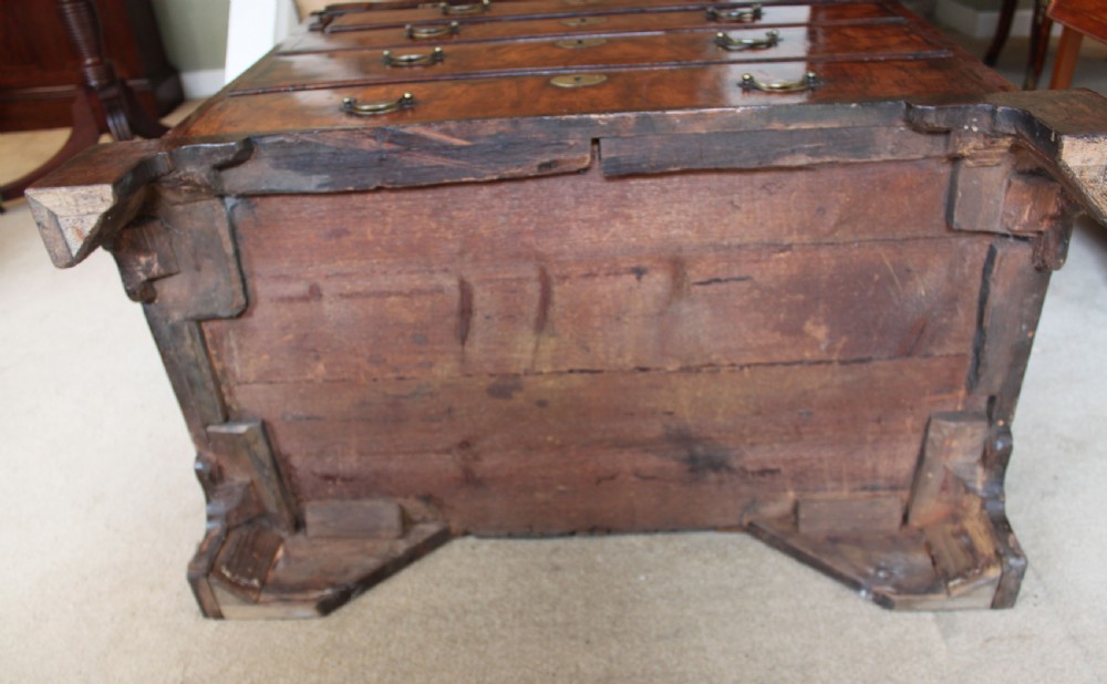 An early 18th-century George I walnut bureau featuring a sloping fall-front lid above four graduated drawers with brass drop handles and bracket feet. View IX