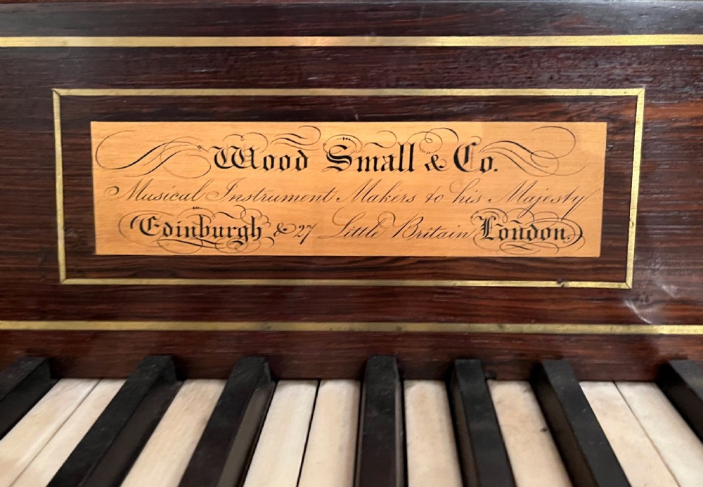 A Regency mahogany square piano crafted by Wood, Small and Co, raised on turned reeded legs with brass castors and featuring an open music rest. View III