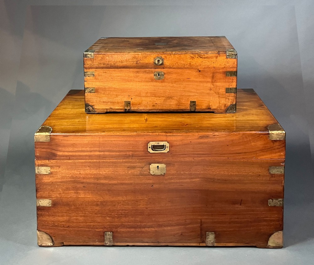 An antique rectangular camphor wood campaign chest featuring recessed brass handles, corner brackets, and a central brass escutcheon. View VI