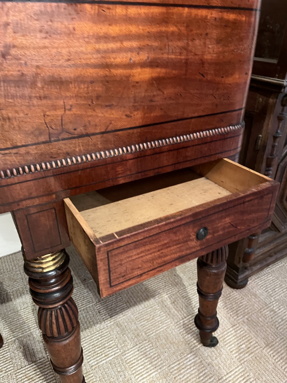 A Regency mahogany square piano crafted by Wood, Small and Co, raised on turned reeded legs with brass castors and featuring an open music rest. View VIII
