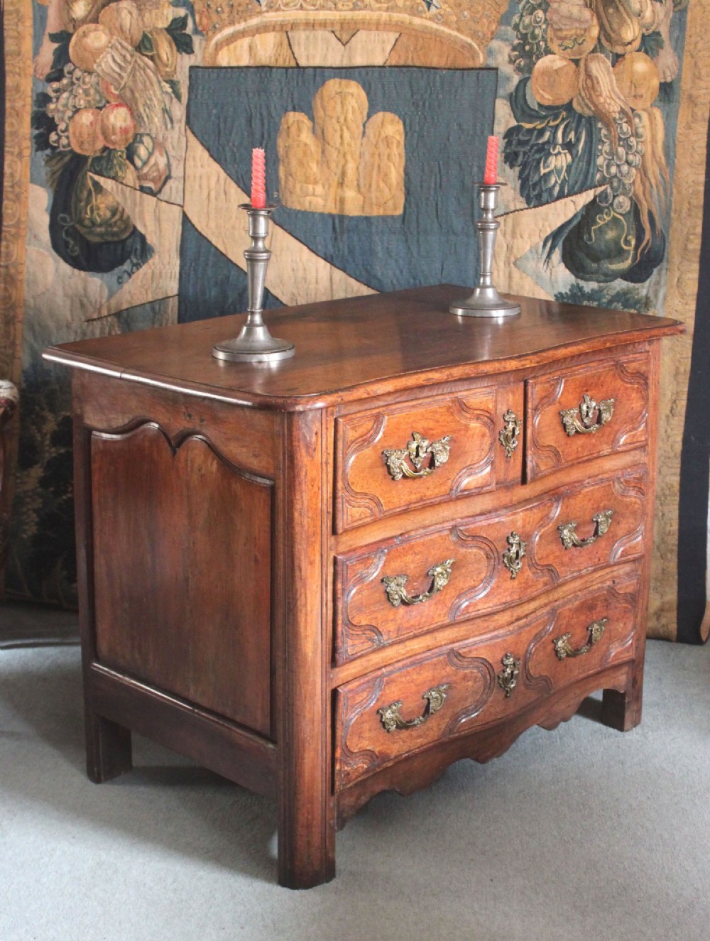 An 18th-century French Provincial walnut commode featuring three carved drawers with serpentine fronts and brass hardware. View II