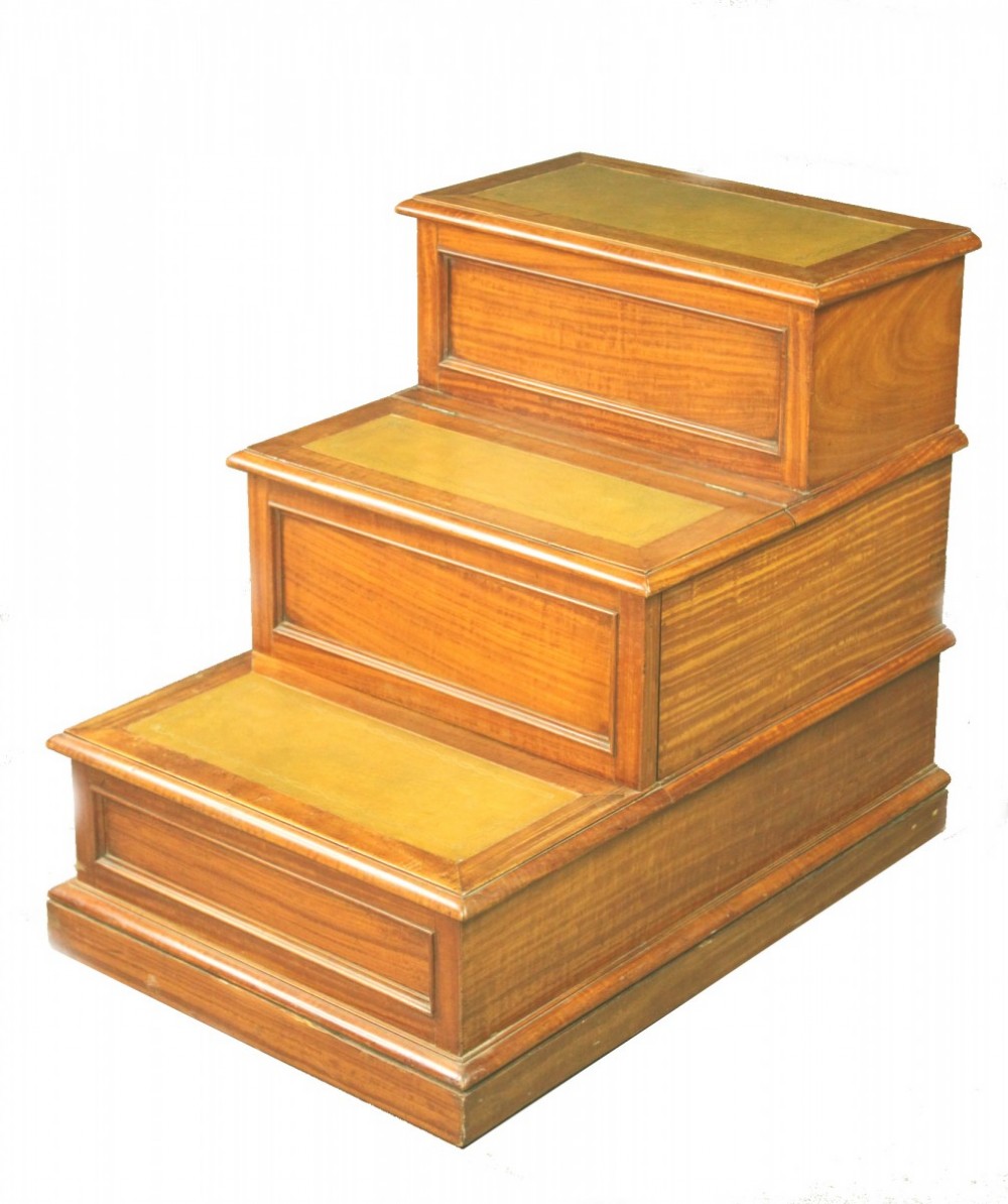 A three-tiered antique satinwood bed step unit featuring golden brown leather inset treads and rectangular panel detailing.