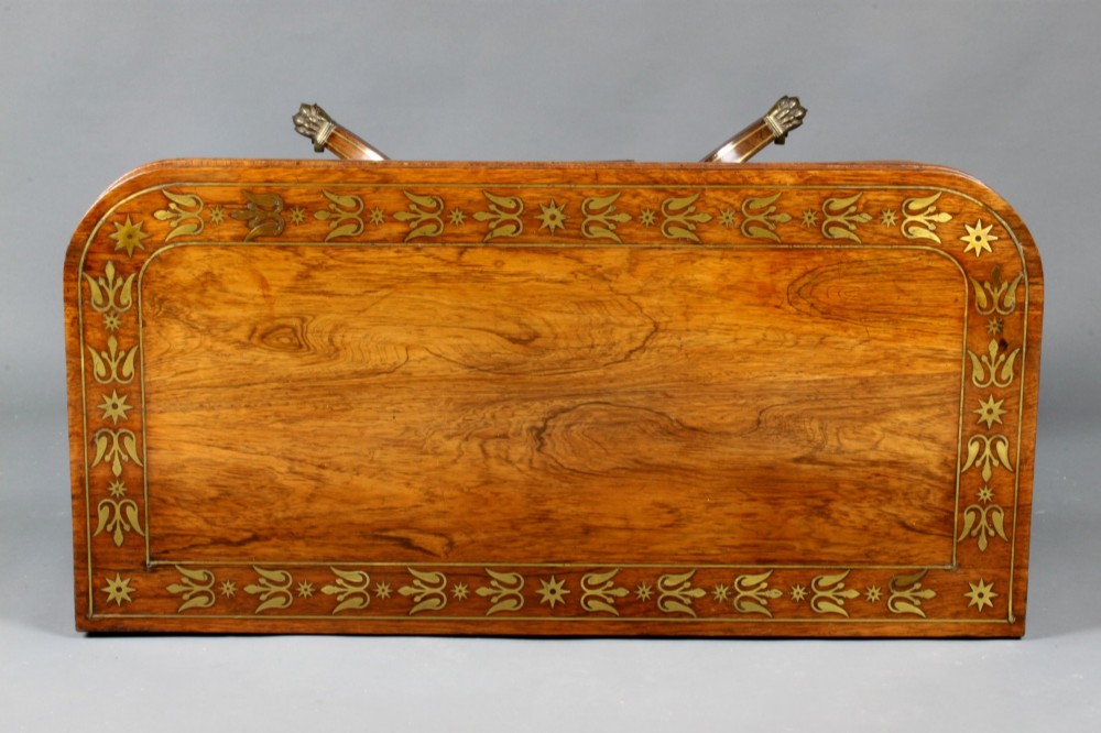 A pair of Regency rosewood card tables featuring brass foliate inlay, fold-over tops, pedestal bases, and splayed legs with brass paw castors. View VIII