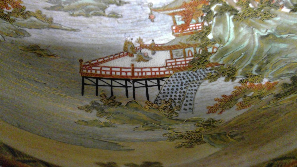 A circular Japanese Satsuma ceramic bowl featuring a hand-painted interior landscape with pagodas, trees, mountains, and gilt accents. View III