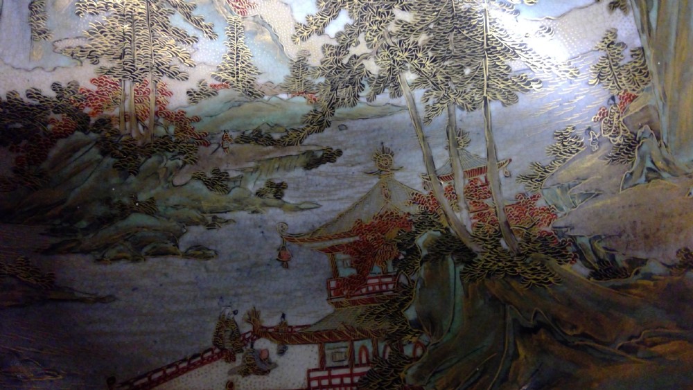 A circular Japanese Satsuma ceramic bowl featuring a hand-painted interior landscape with pagodas, trees, mountains, and gilt accents. View IV