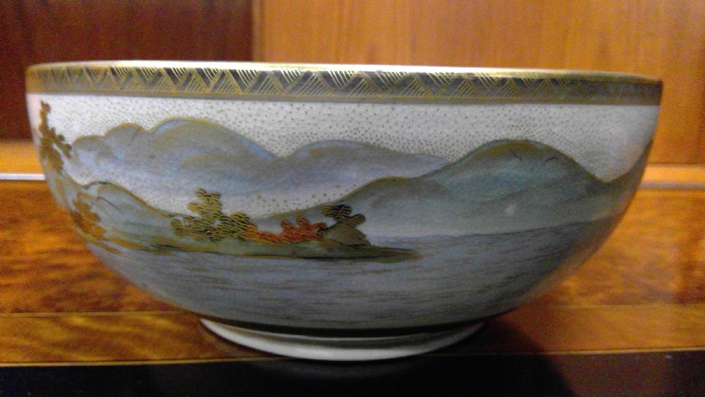 A circular Japanese Satsuma ceramic bowl featuring a hand-painted interior landscape with pagodas, trees, mountains, and gilt accents. View VIII