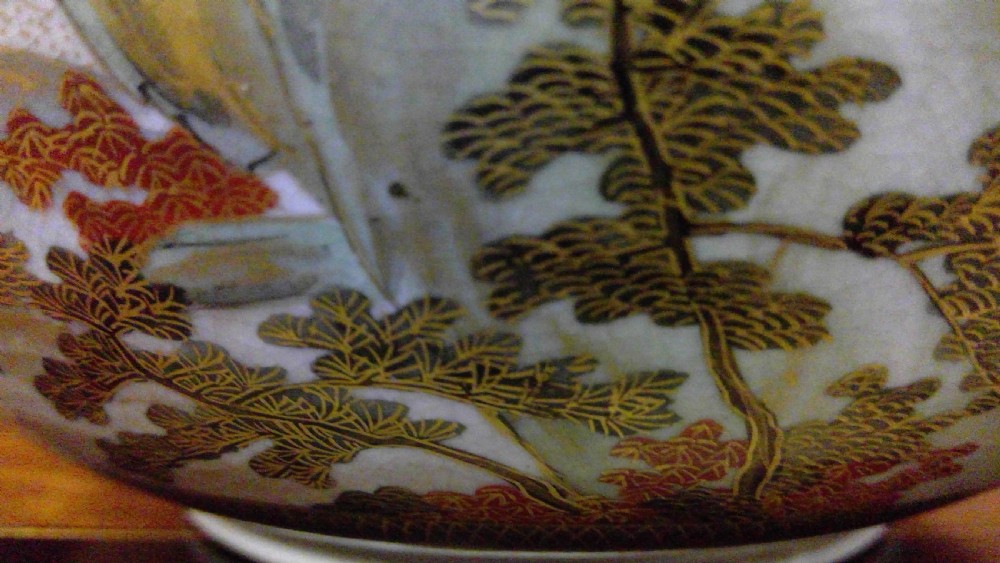 A circular Japanese Satsuma ceramic bowl featuring a hand-painted interior landscape with pagodas, trees, mountains, and gilt accents. View XI