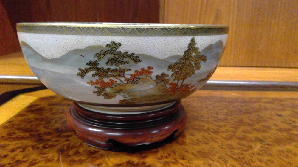 A circular Japanese Satsuma ceramic bowl featuring a hand-painted interior landscape with pagodas, trees, mountains, and gilt accents. View XIII