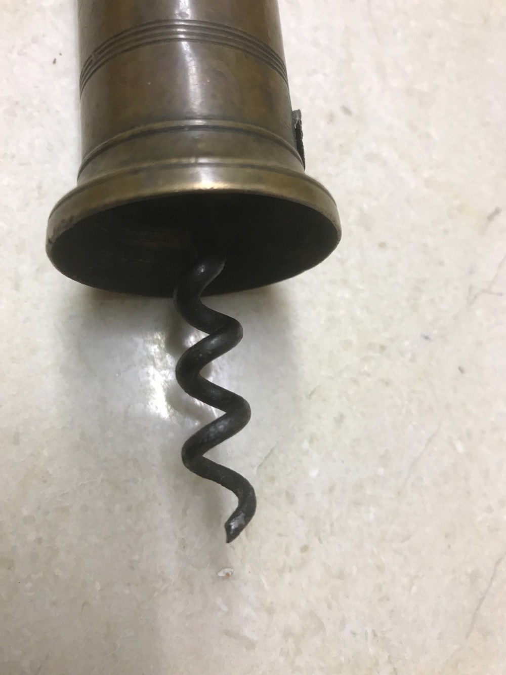 An antique Victorian mechanical brass corkscrew with a ribbed turned bone handle, an integrated dusting brush, and a steel helix worm at the base. View V