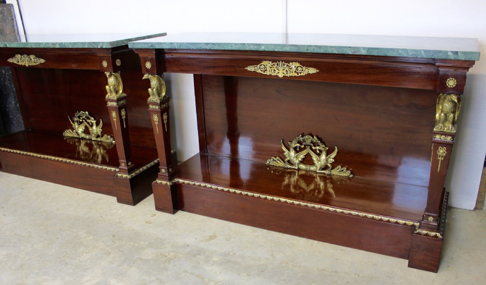 A pair of dark mahogany French Empire console tables featuring green marble tops, winged eagle supports, lower plinth shelves, and ornate gilt bronze mounts. View II
