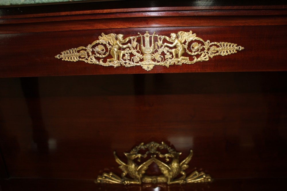 A pair of dark mahogany French Empire console tables featuring green marble tops, winged eagle supports, lower plinth shelves, and ornate gilt bronze mounts. View III