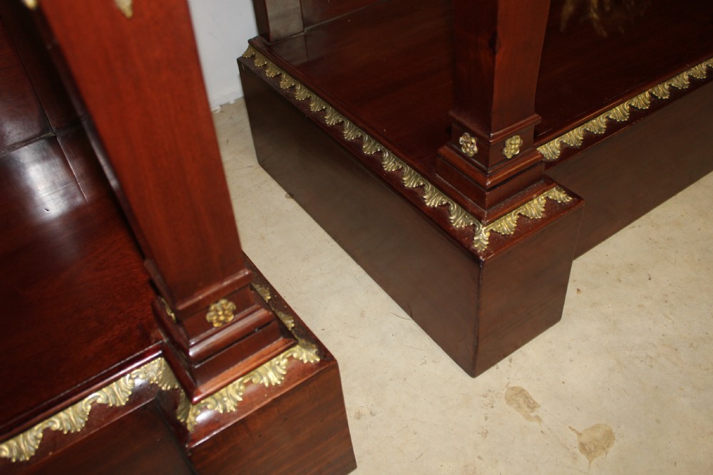A pair of dark mahogany French Empire console tables featuring green marble tops, winged eagle supports, lower plinth shelves, and ornate gilt bronze mounts. View XI