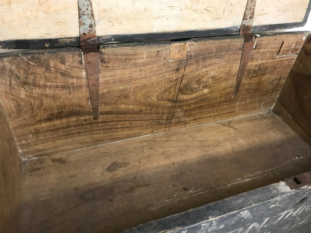 Two stacked dark painted antique wooden military trunks featuring original stencilled regimental lettering and iron brackets. View VIII