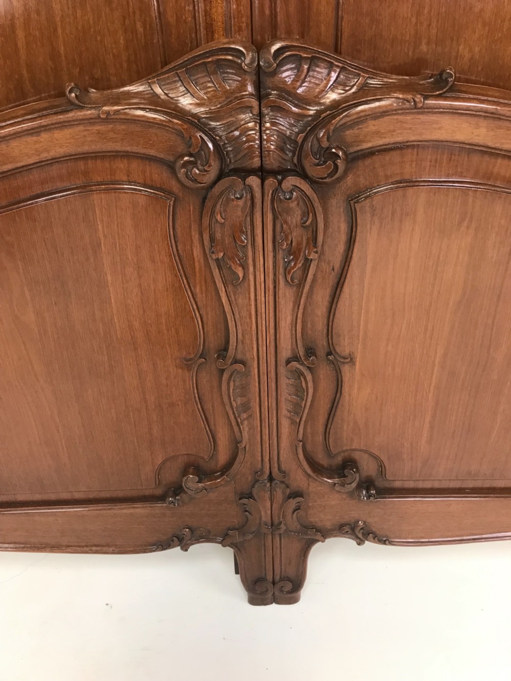 A carved mahogany king size bed frame featuring an arched headboard and matching footboard with intricate foliate detailing and cabriole feet. View II