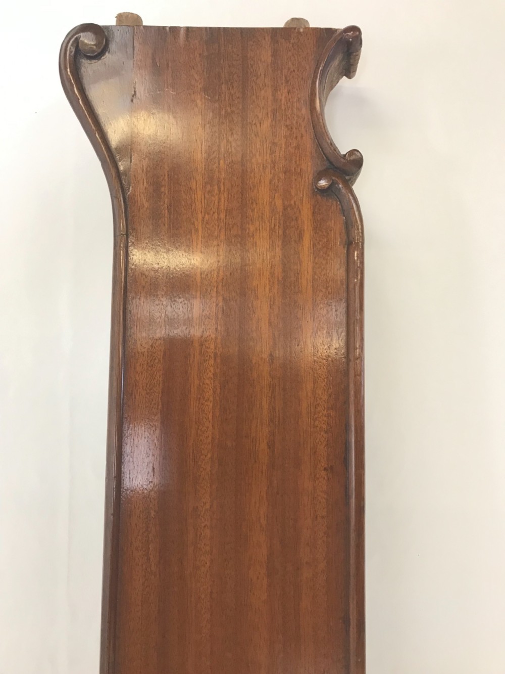 A carved mahogany king size bed frame featuring an arched headboard and matching footboard with intricate foliate detailing and cabriole feet. View VII